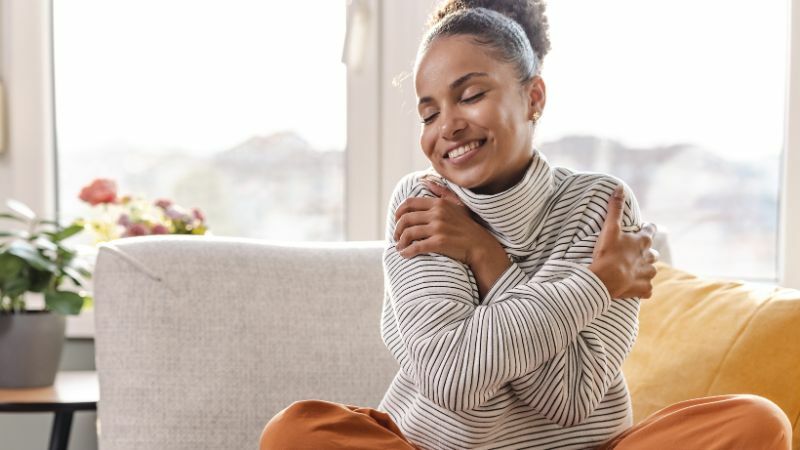 Woman hugging herself